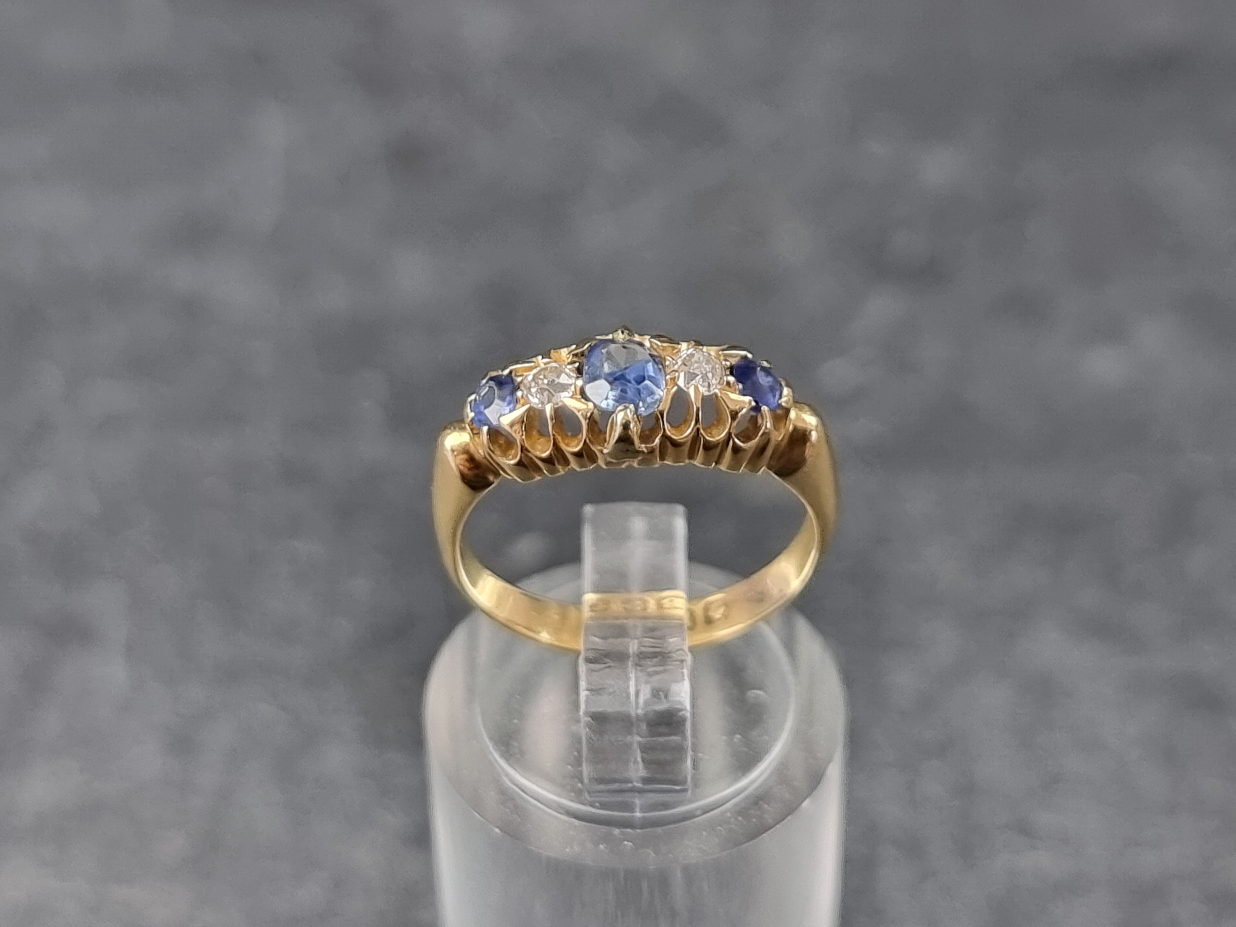 An Edwardian 18ct gold diamond and sapphire five stone ring, Birmingham 1905, size K 1/2, gross