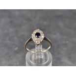 A white metal sapphire and diamond ring, size M.