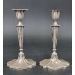 A pair of silver candlesticks, by Walker & Hall, Sheffield 1911, 25cm high, weighted.