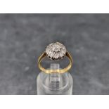 A diamond daisy cluster ring, stamped '18/Plat', size L 1/2.