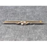 A yellow metal bar brooch, set two brilliant cut diamonds, stamped 15ct/plat, 56mm long.