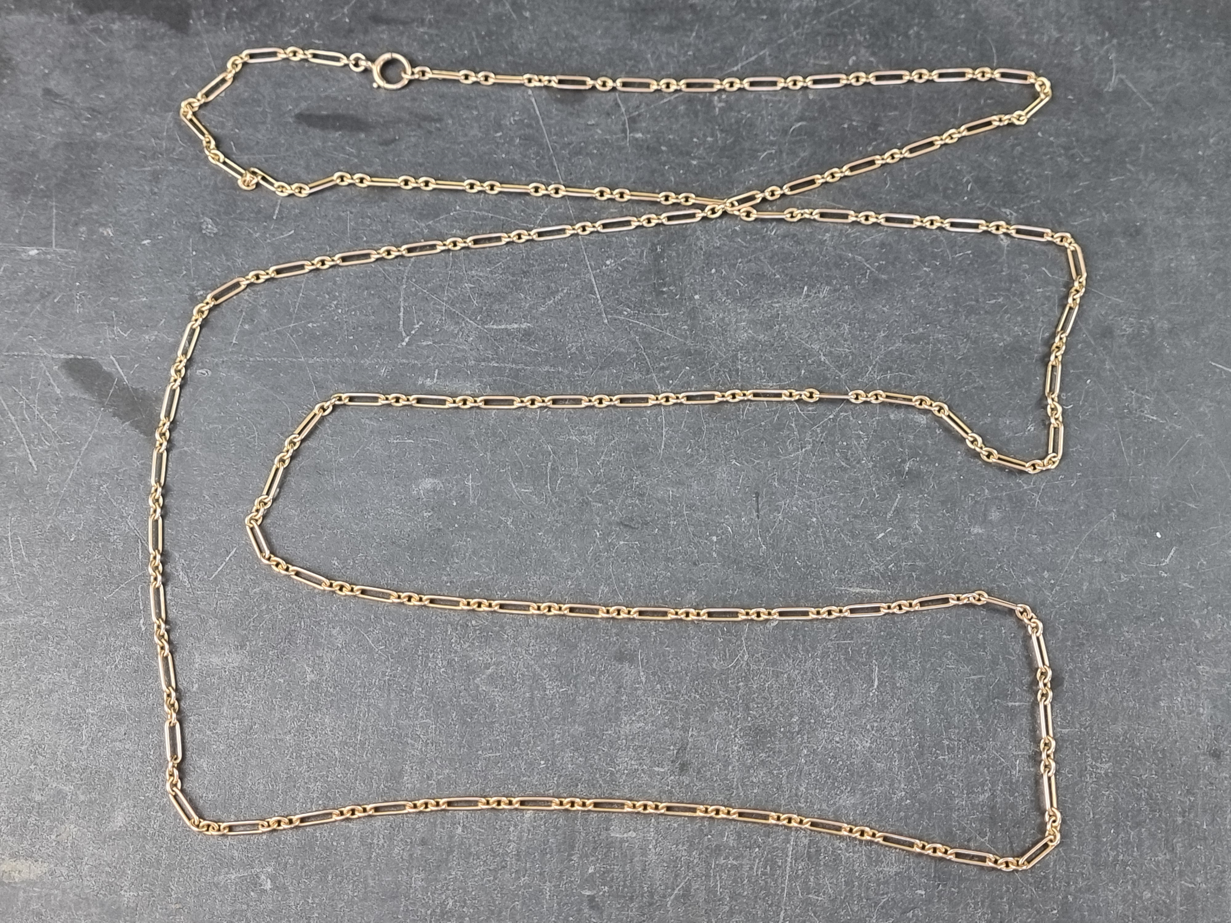 A Victorian yellow metal trombone link longuard necklace, marked 15ct, 144cm long.