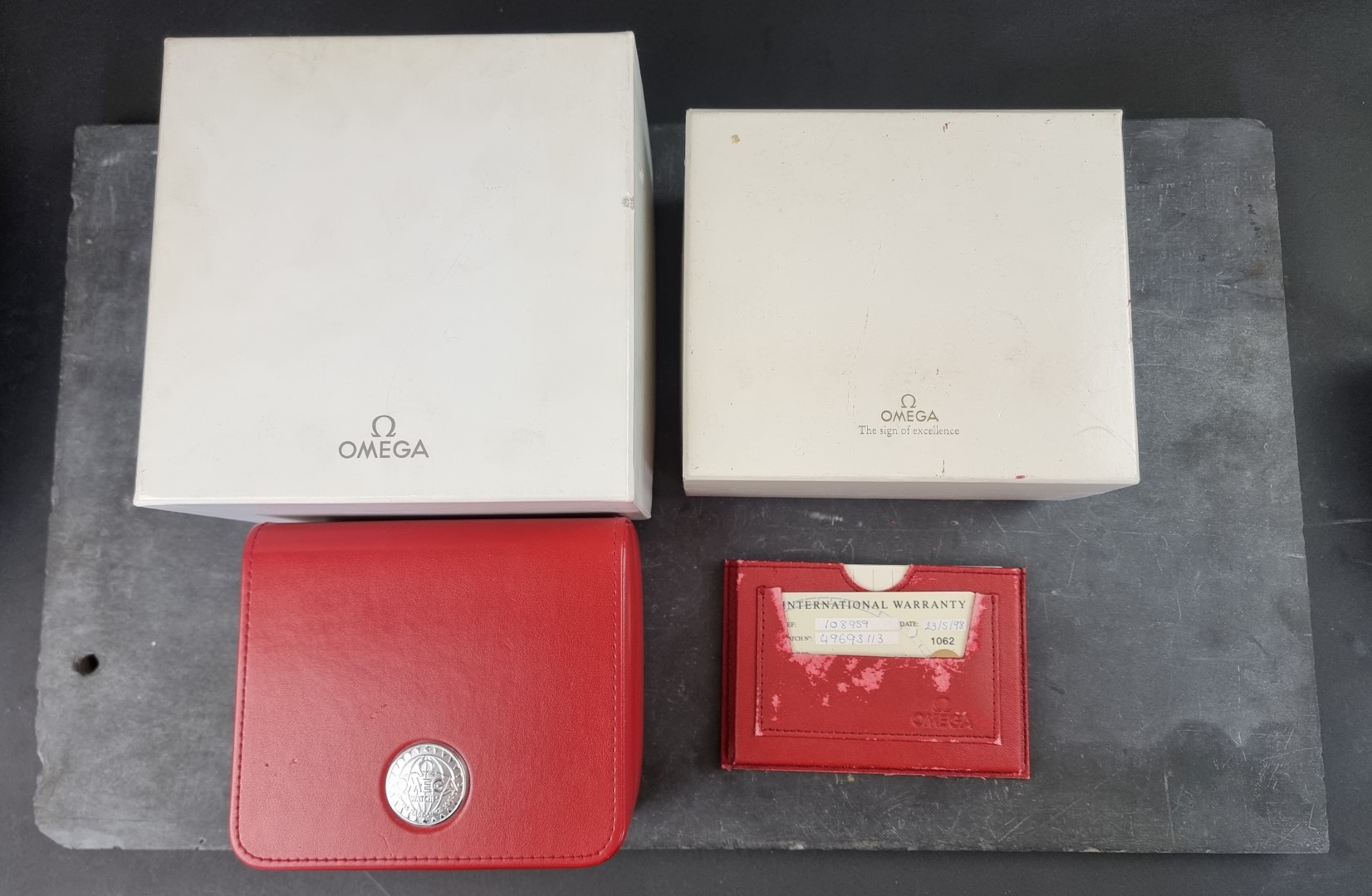 A Omega wristwatch box; with outer card box; chronometer guarantee booklet; and other papers;