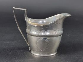 A George III silver milk jug, probably by Thomas Wheatley, Newcastle, height to handle 11cm, 116g.