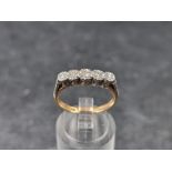 A yellow metal diamond five stone ring, illusion set, stamped '18ct & plat', size O.