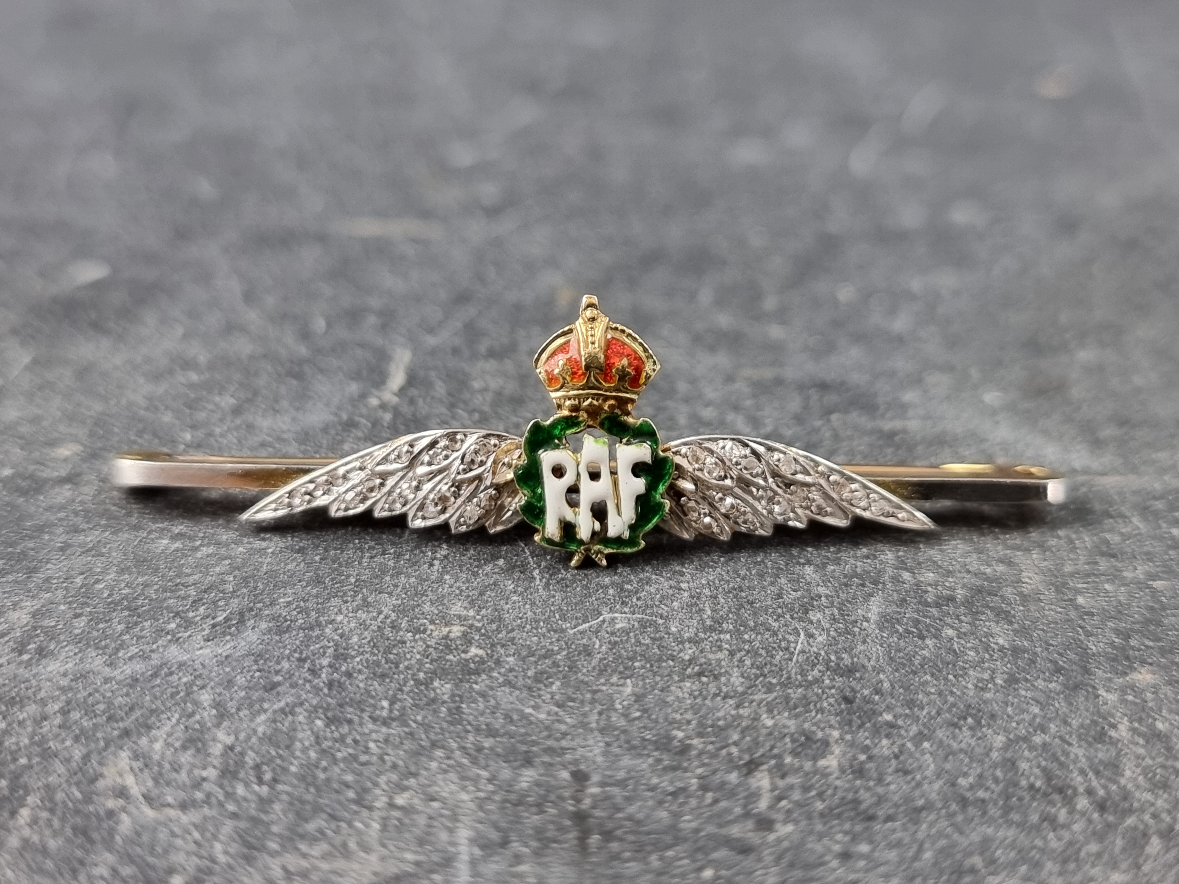 A yellow metal, enamel and diamond set RAF sweetheart brooch, stamped '15ct', 51mm wide.