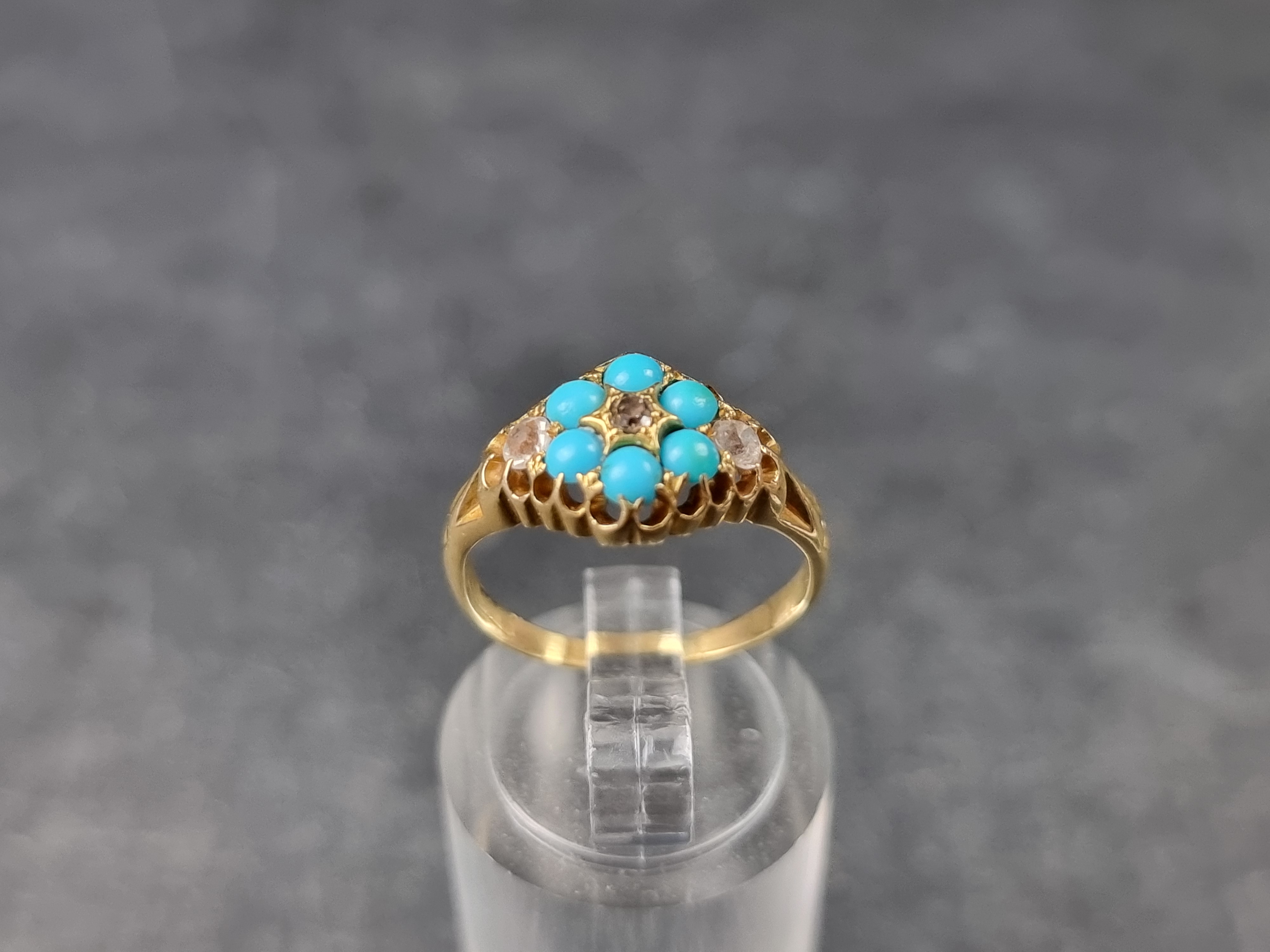 A Victorian yellow metal ring, set one diamond, two colourless gemstones and six cabochon turquoise,