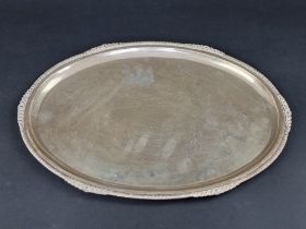 A white metal oval tray, stamped 'silver', 38.5cm wide.