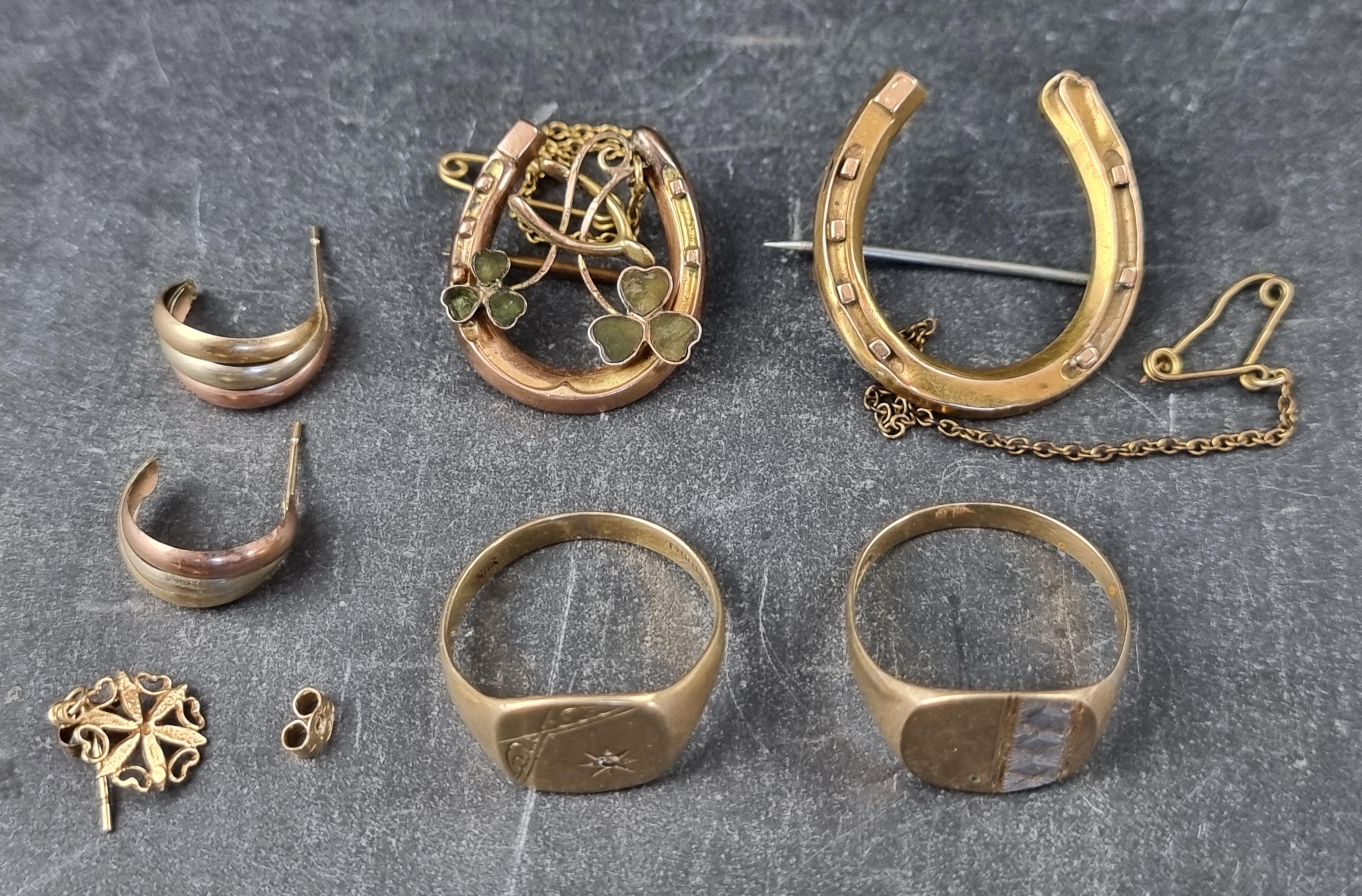 Two 9ct gold signet rings and a 9ct gold horseshoe brooch, 9.4g; together with a pair of yellow