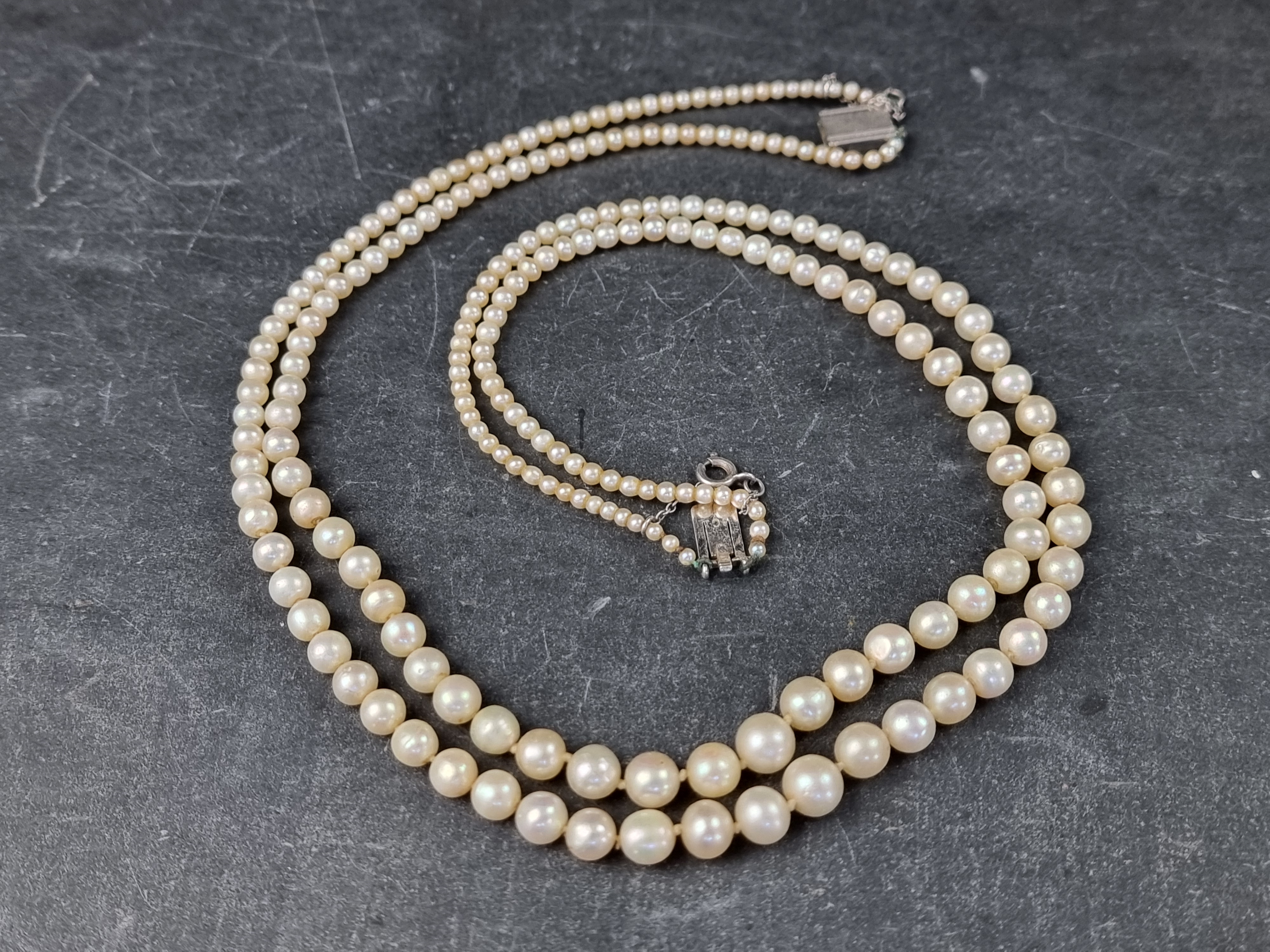 A cased pearl graduated necklace, the clasp stamped '9ct', 43cm long.