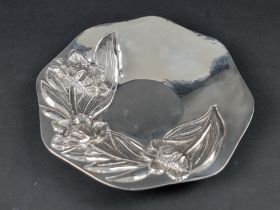 A white metal dish, stamped '.900' and 'NE', 23.5cm diameter.