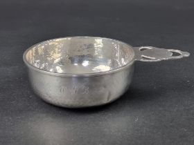 A silver bowl, having single pierced handle, , by A E Jones, Birmingham 1929, 16cm wide, 109g.