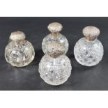 Four various silver mounted cut glass scent bottles.