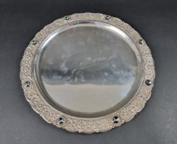 A white metal tray, having faceted glass jewels to rim, stamped 'silver', 35cm diameter.