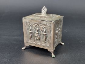 An Eastern metal lidded box, the lid decorated Ganesh, 12cm high.