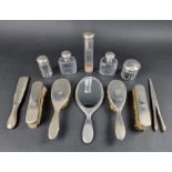 An engine turned silver dressing table set, comprising: four brushes, a mirror, a shoe horn, five