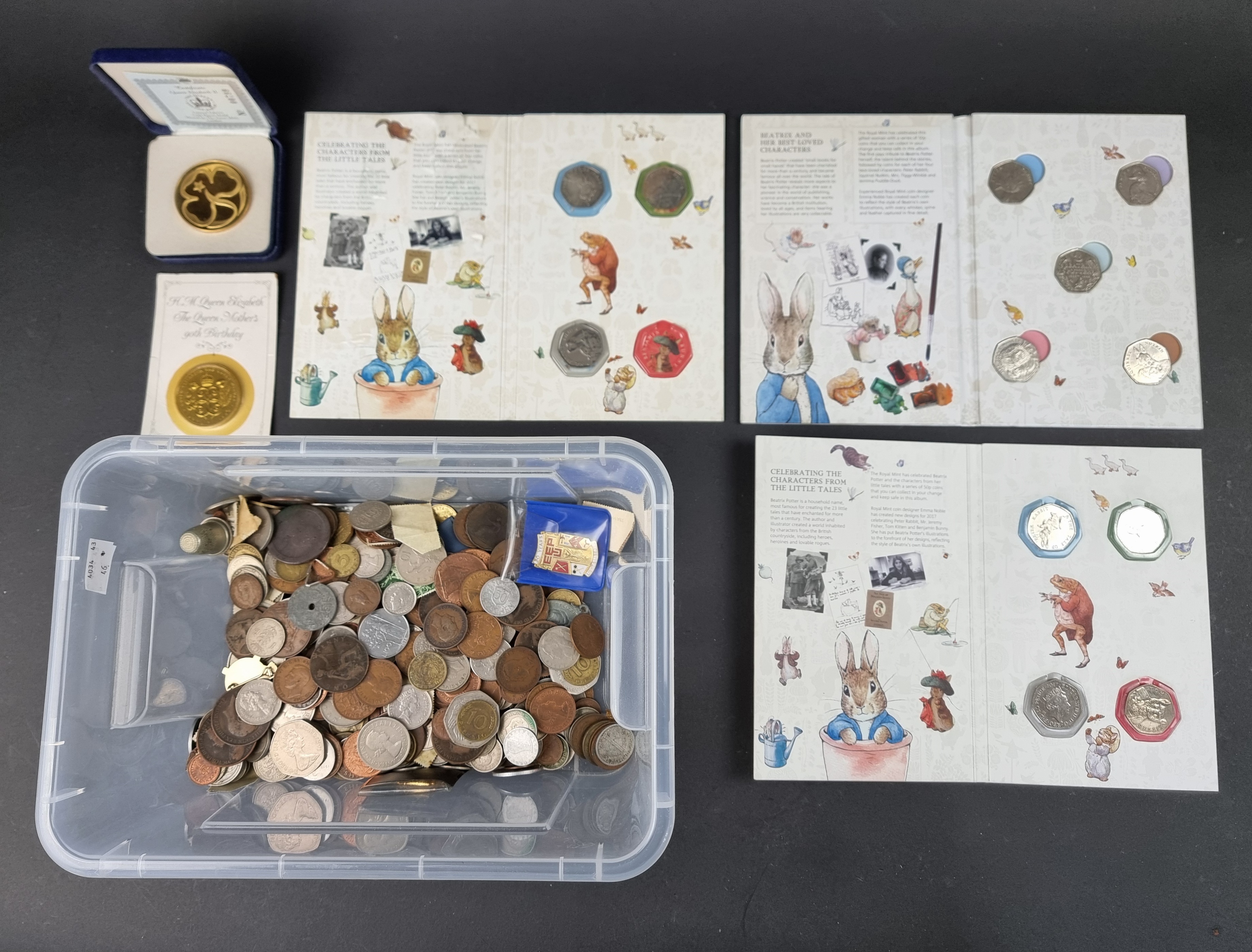 Coins: a quantity of UK and world coins; to include twelve Beatrix Potter fifty pence coins and a
