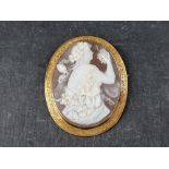 A Victorian carved shell cameo brooch of a Bacchante, in an engraved yellow metal frame, 6.5cm x 5.