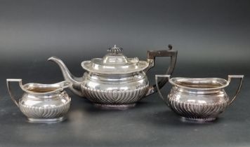 An Edwardian silver three piece tea set, by Cooper Brothers & Sons Ltd, Sheffield 1909/10, teapot