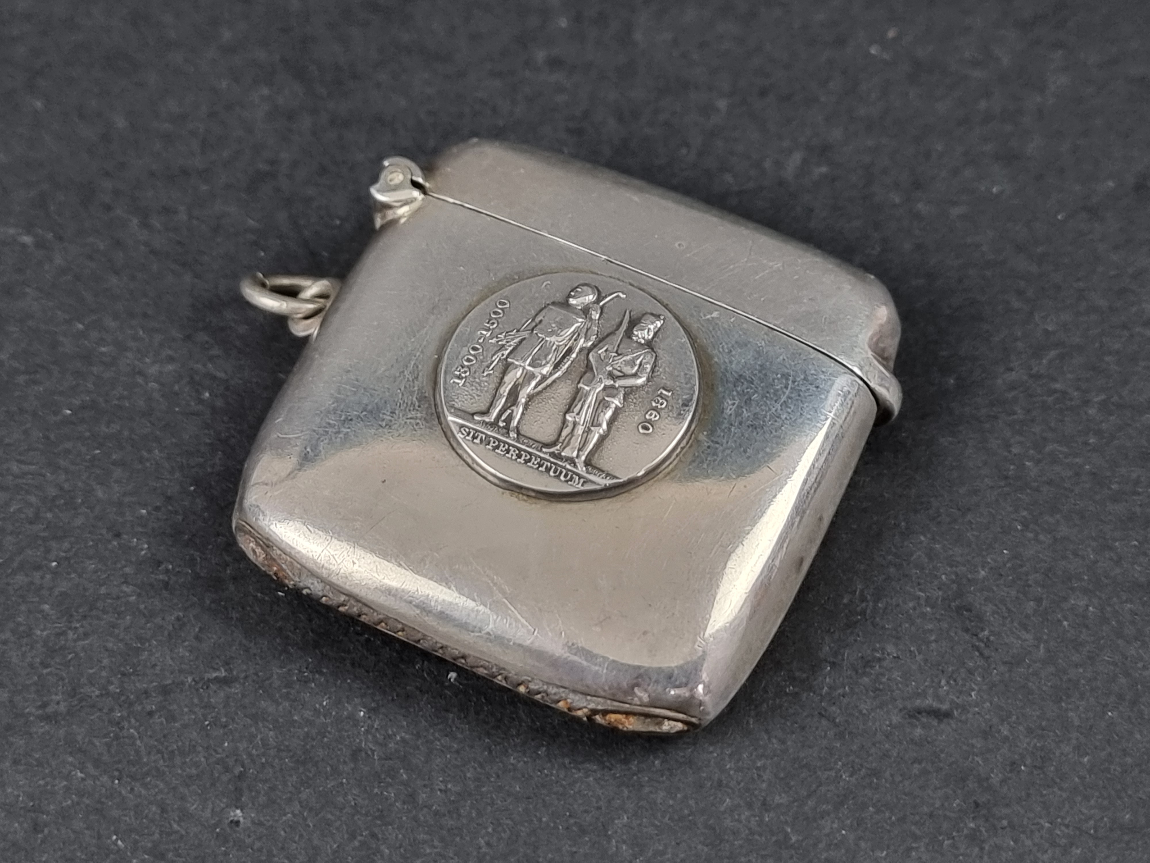 A silver vesta case, decorated the emblem of the National Rifle Association (GB), by Charles S Green