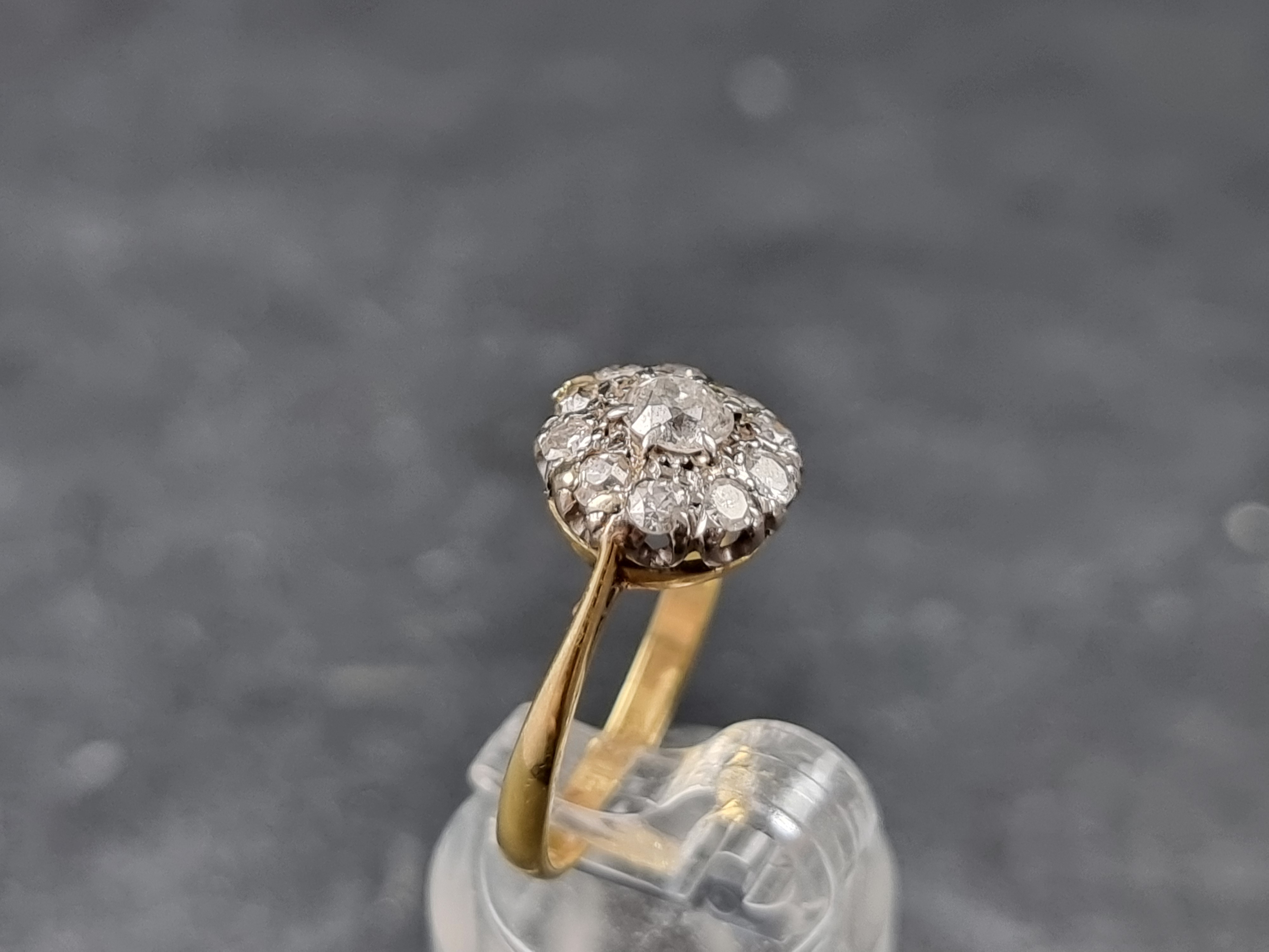 A diamond daisy cluster ring, stamped '18/Plat', size L 1/2. - Image 3 of 3