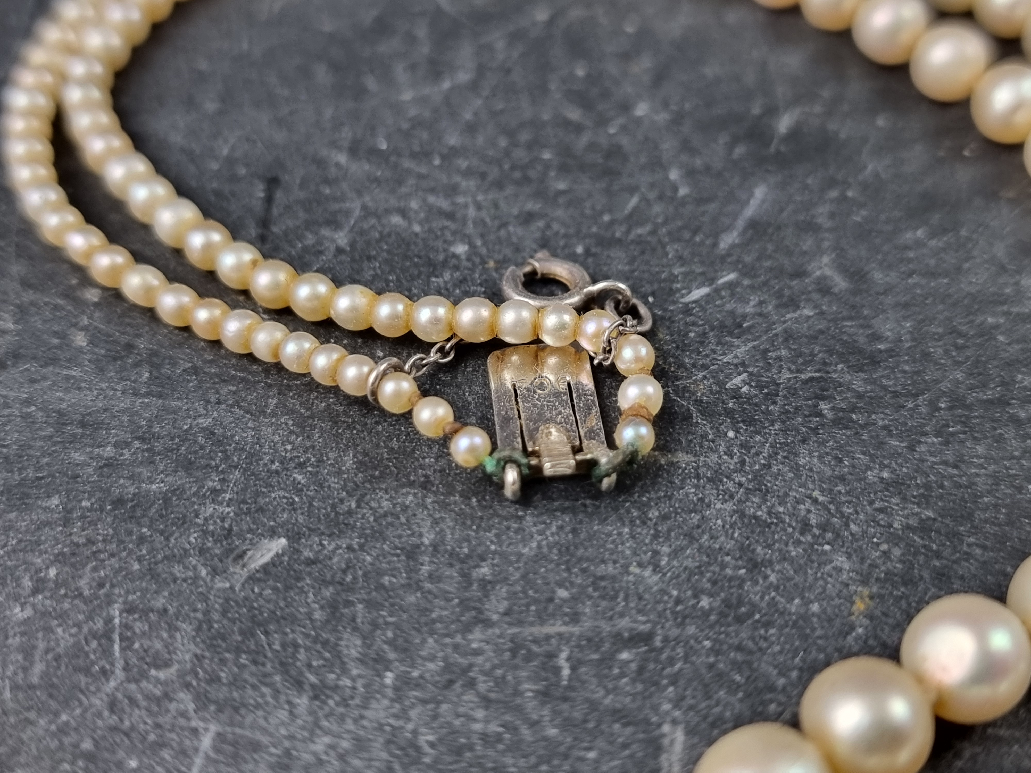 A cased pearl graduated necklace, the clasp stamped '9ct', 43cm long. - Image 2 of 3