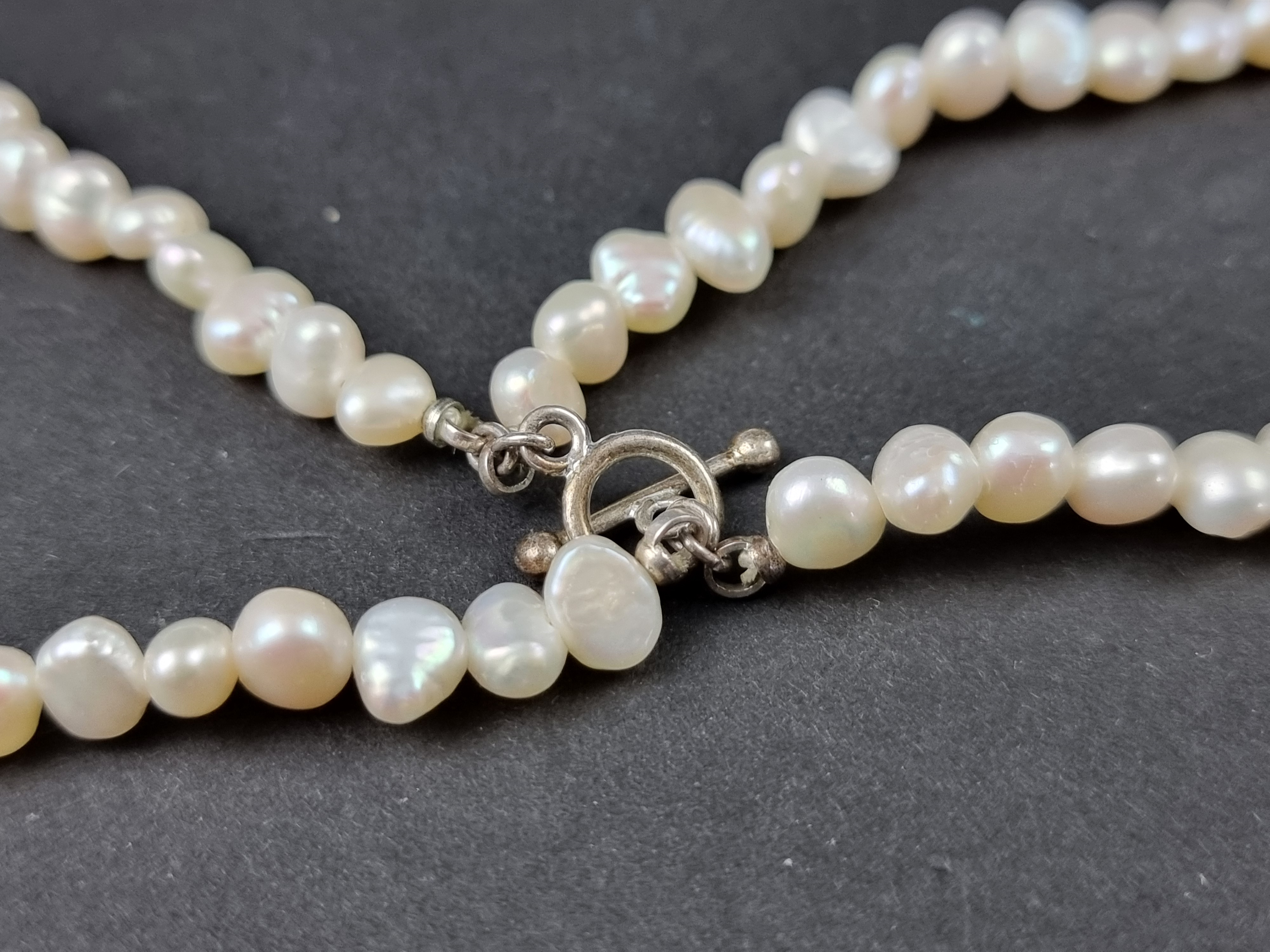 A cultured pearl necklace, having yellow metal clasp set pearl and four sapphires, stamped '9ct', - Image 3 of 3