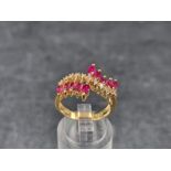 A yellow metal ruby and diamond ring, stamped '750', size N.