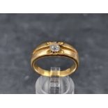 A yellow metal ring, set single claw set diamond of approximately 0.5ct, stamped '18', size U.