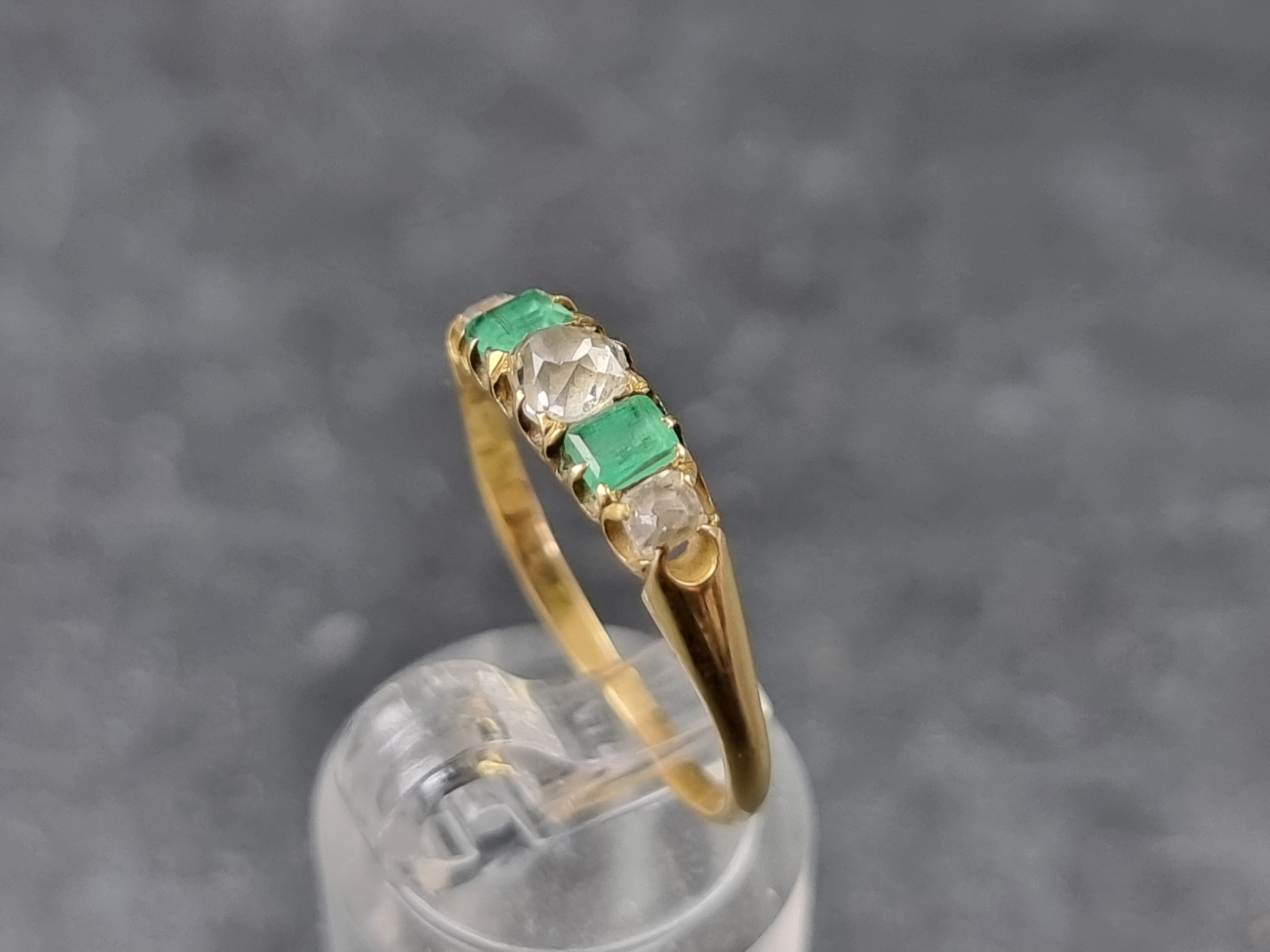 A yellow metal emerald and diamond five stone ring, set three graduated old cut diamonds and two - Image 2 of 3