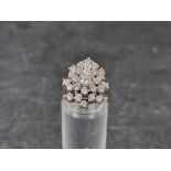 A diamond set white metal cocktail ring, stamped '14k', set with 27 brilliant cut diamonds, size O