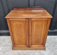 An Edwardian mahogany, satinwood crossbanded and line inlaid side cabinet, 75cm wide.