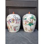 A pair of Chinese famille rose ovoid jars and covers, 31.5cm high.