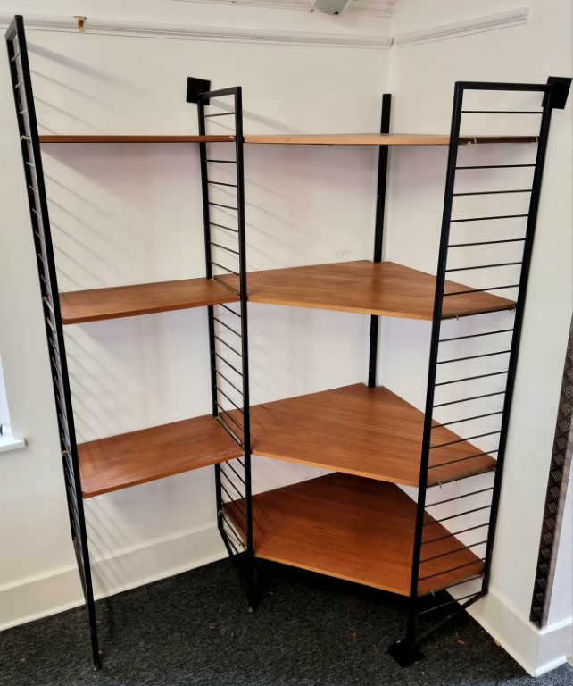 A scarce mid-century Ladderax corner unit.