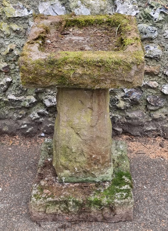 An old weathered composition stone pedestal bird bath, 76cm high; together with another garden