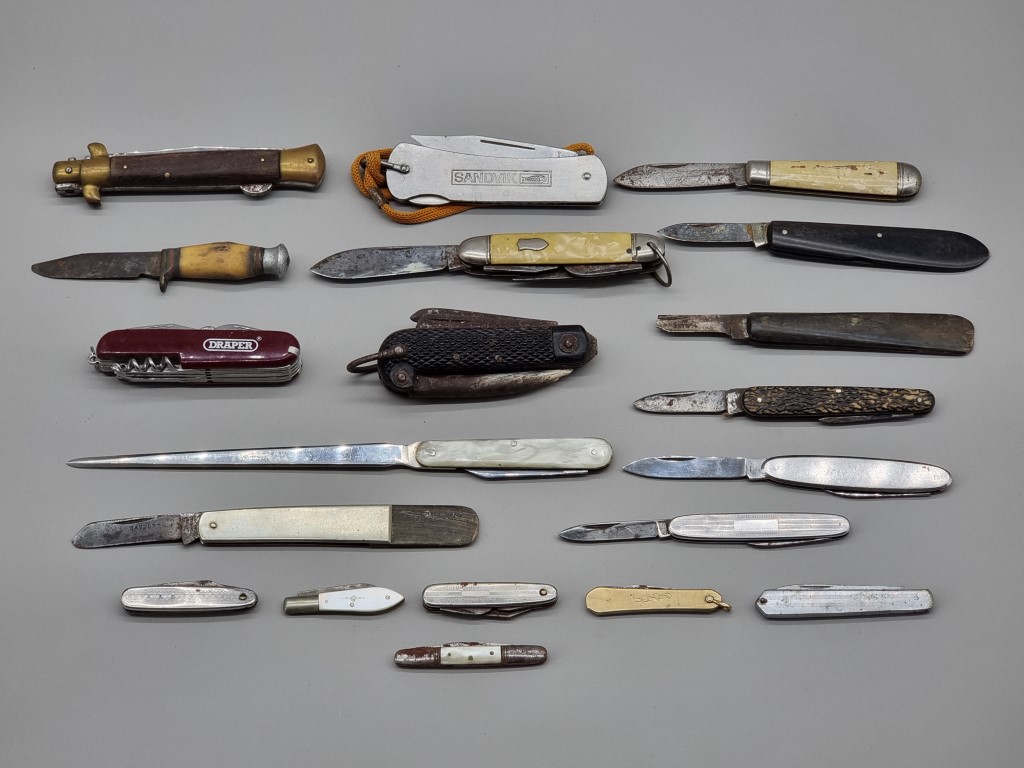 A collection of vintage penknives, to include a small silver bladed example.