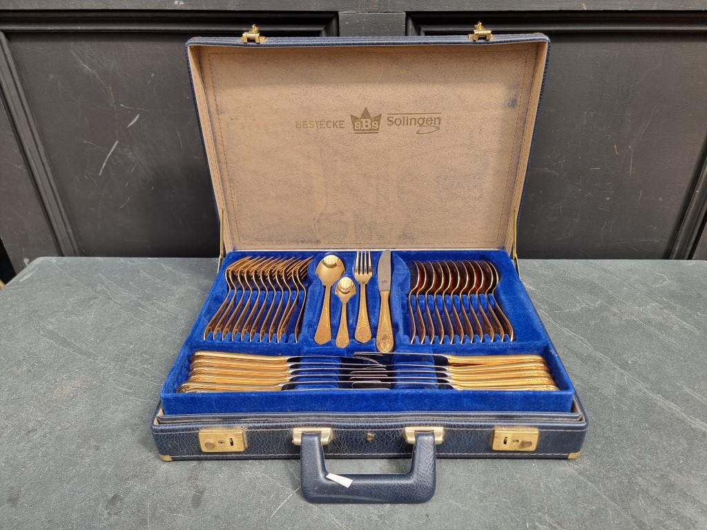 A case of gilt plated cutlery, for eleven, by Bestecke, Solingen.