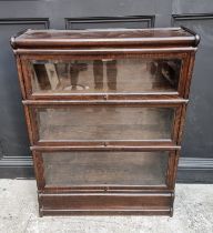 An early 20th century Globe Wernicke oak three tier sectional bookcase, with bevelled glass, 86.