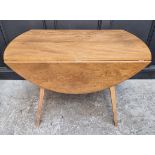 A mid-century Ercol Windsor drop leaf dining table, 113cm wide.