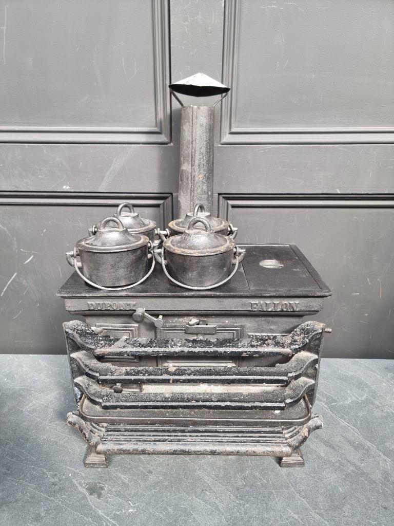 A scarce 19th century French cast iron miniature stove, inscribed 'Dupont, Fallon', the top 37cm