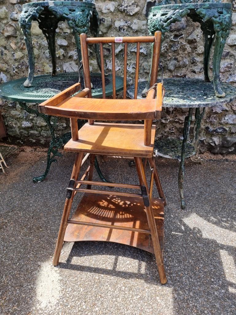 A vintage beech and plywood child's highchair.