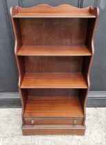 A reproduction mahogany waterfall bookcase, with apron drawer, 56.5cm wide.