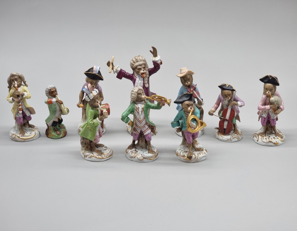 A set of nine Dresden porcelain 'Monkey Band' figures, largest 17cm high; together with another