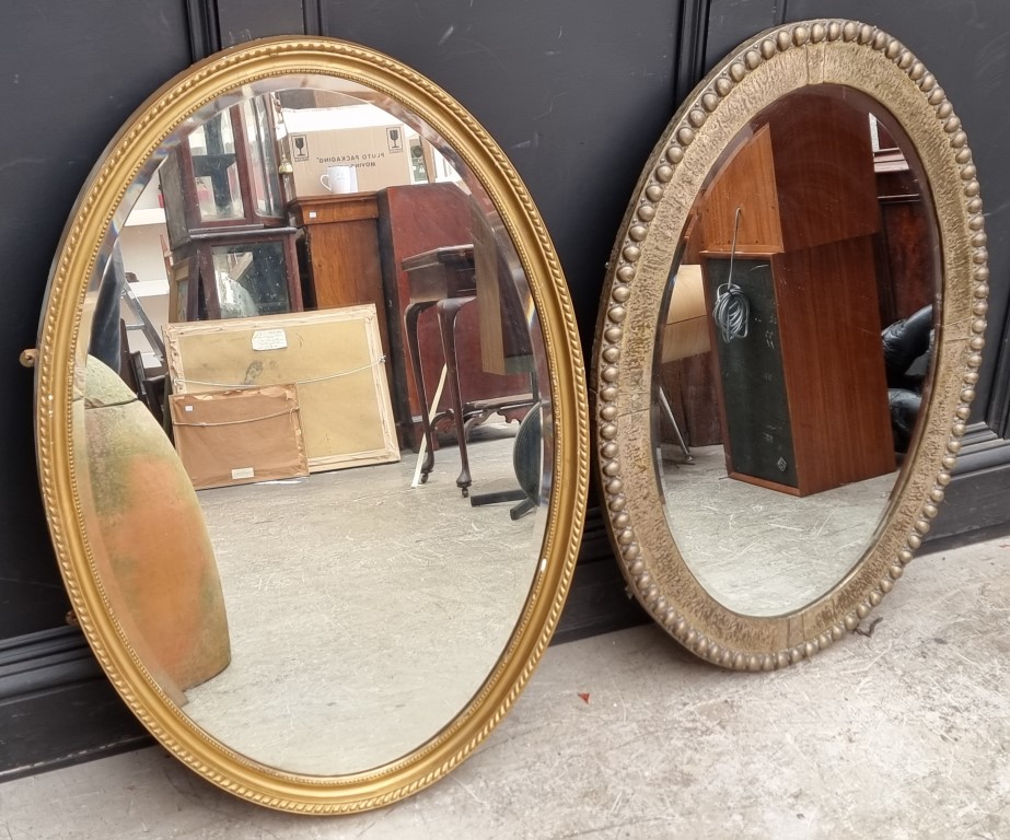 A plated metal framed oval wall mirror, 65 x 90cm; together with another similar gilt framed