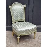A Louis XVI style green and cream painted low occasional chair.