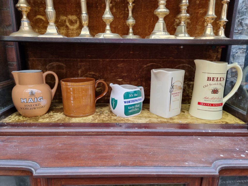 Advertising: four pottery jugs, to include: a Carlton Ware 'Haig' example; together with a novelty