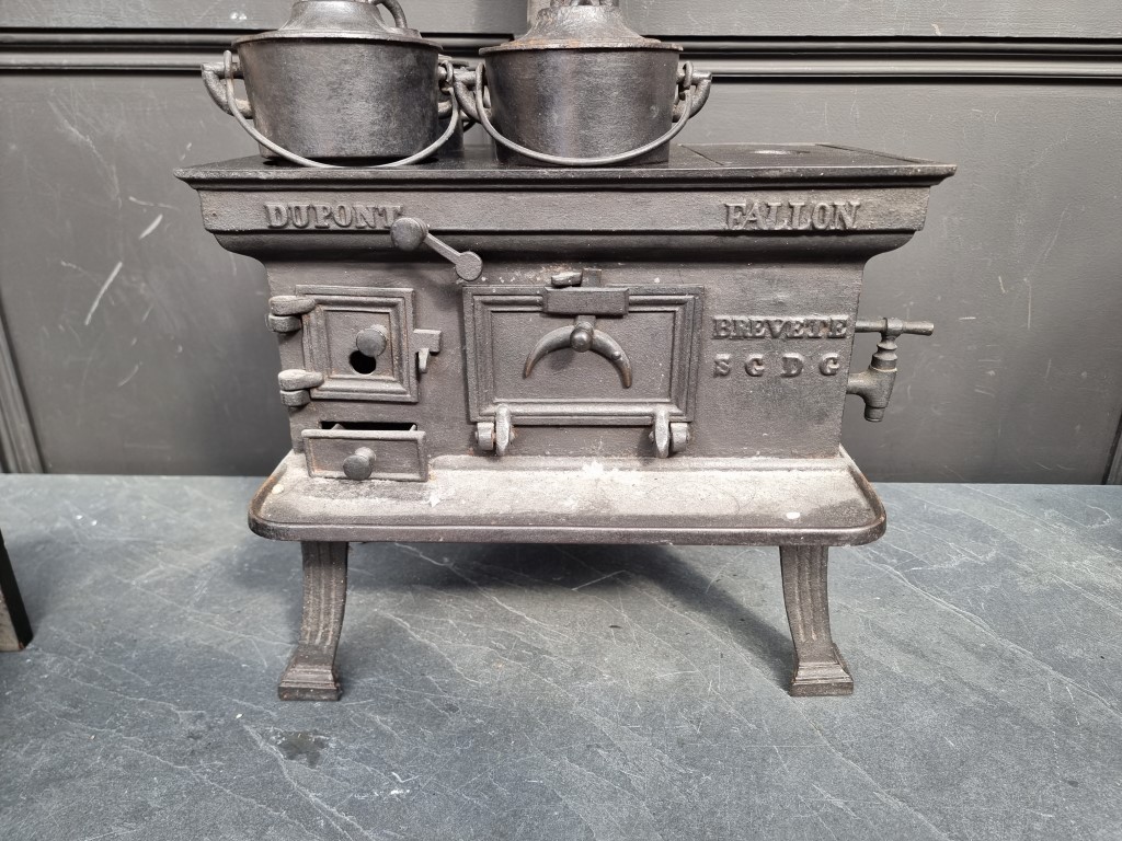 A scarce 19th century French cast iron miniature stove, inscribed 'Dupont, Fallon', the top 37cm - Image 2 of 4