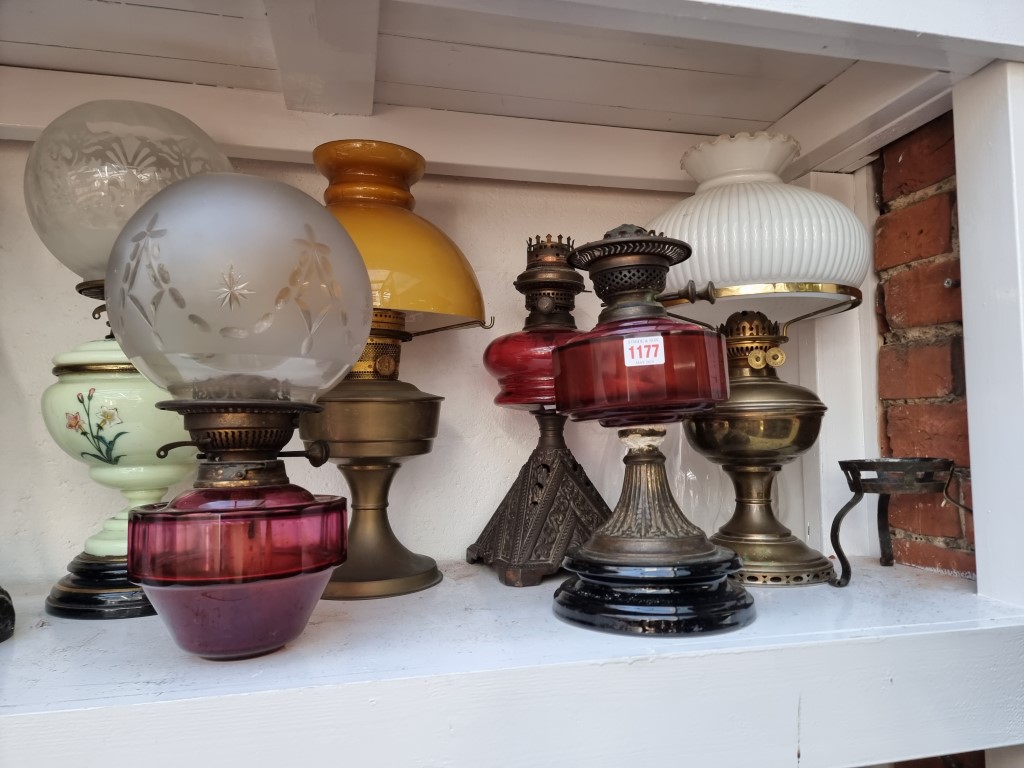 Six antique oil lamps.