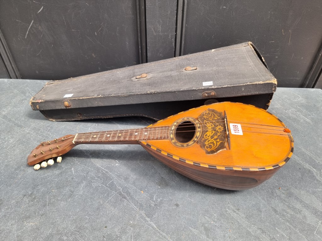 An Italian eight string mandolin, labelled 'Gennaro Maglioni, Napoli', in case.