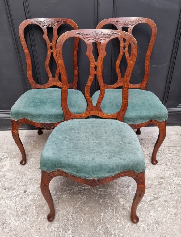 A set of three 18th century Dutch carved walnut and marquetry dining chairs. (3)